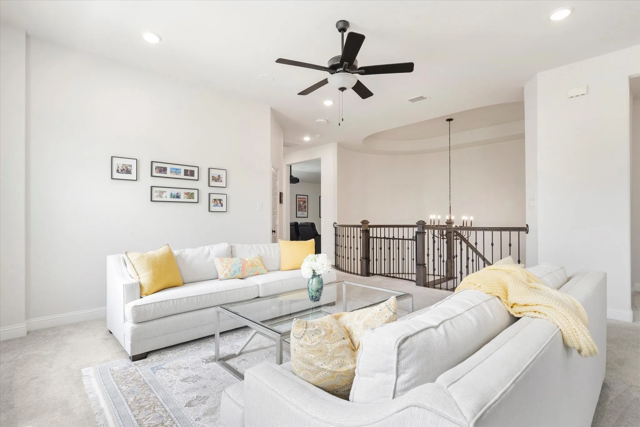 Large Game Room at the top of the stairs surrounded by two bedrooms and a media room.