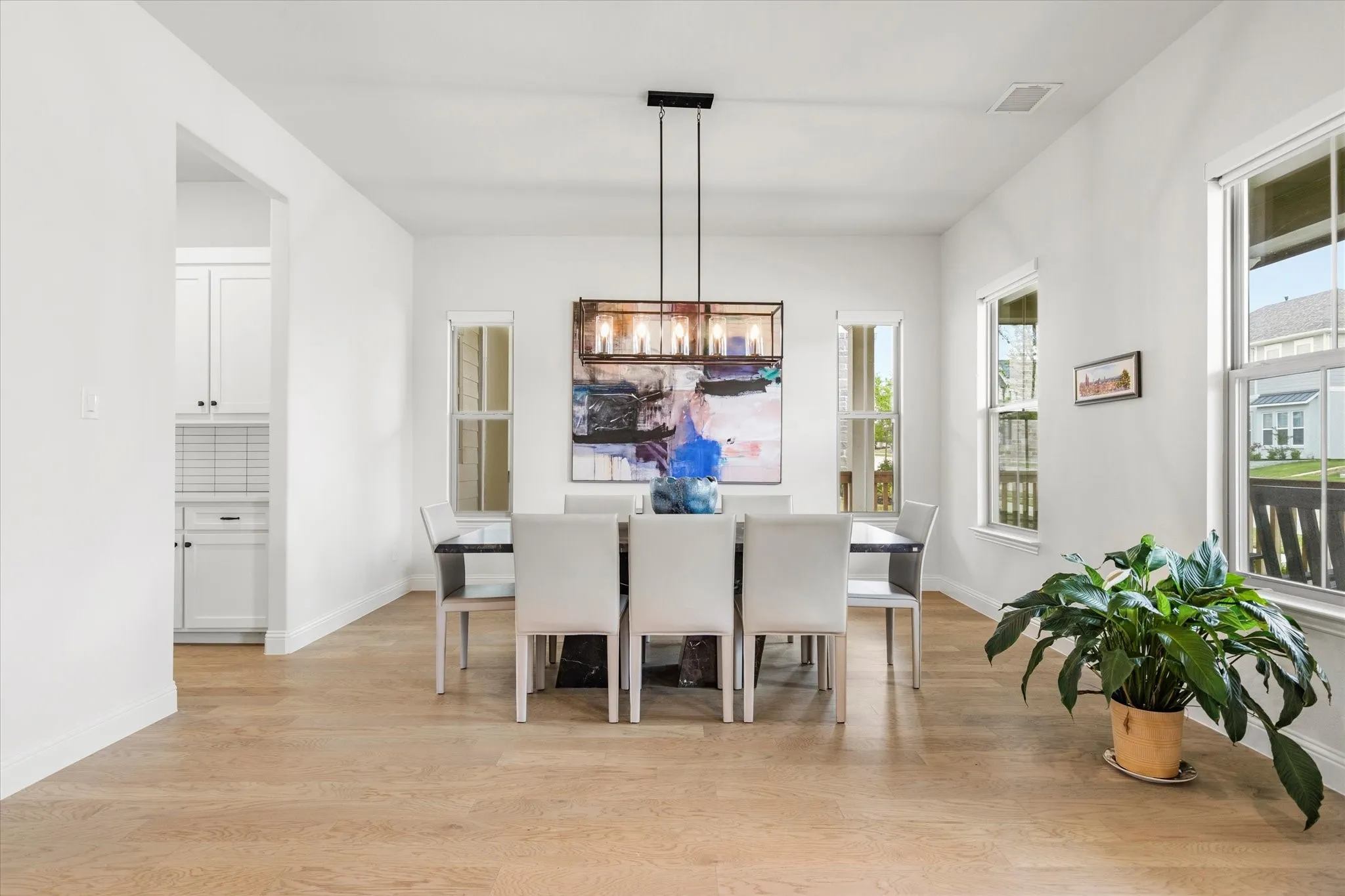 Large Dining room with a beautiful chandelier.  The door to the left leads has a butler pantry that leads to the kitchen.
