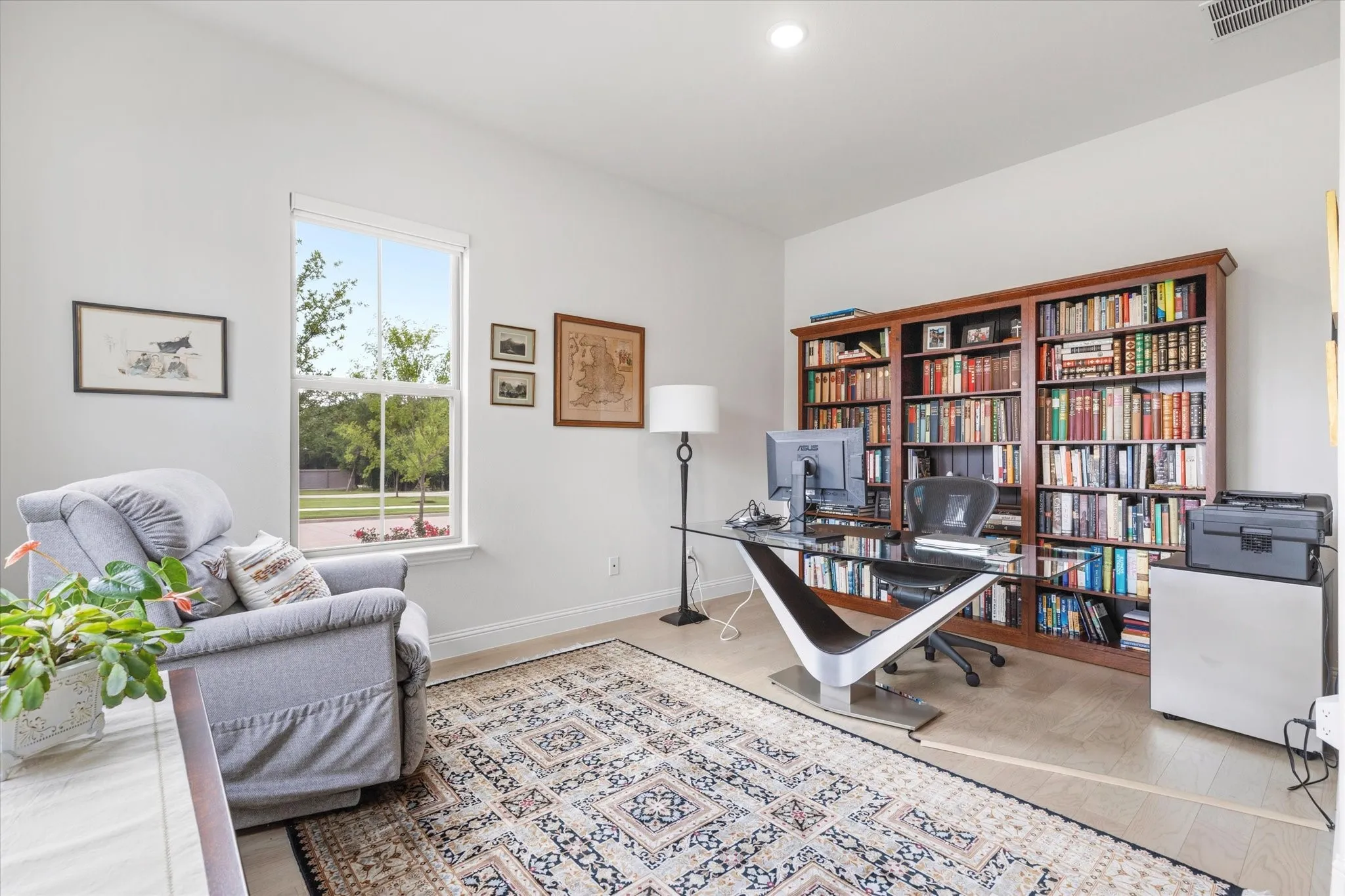 Bedroom that is currently being used as an extra study. Wood flooring and lots of windows