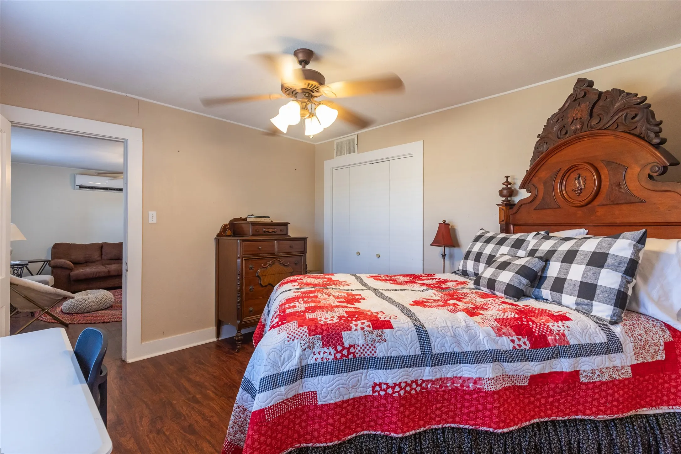 Wood-finish flooring, ceiling fan with integrated lighting, and solid core doors