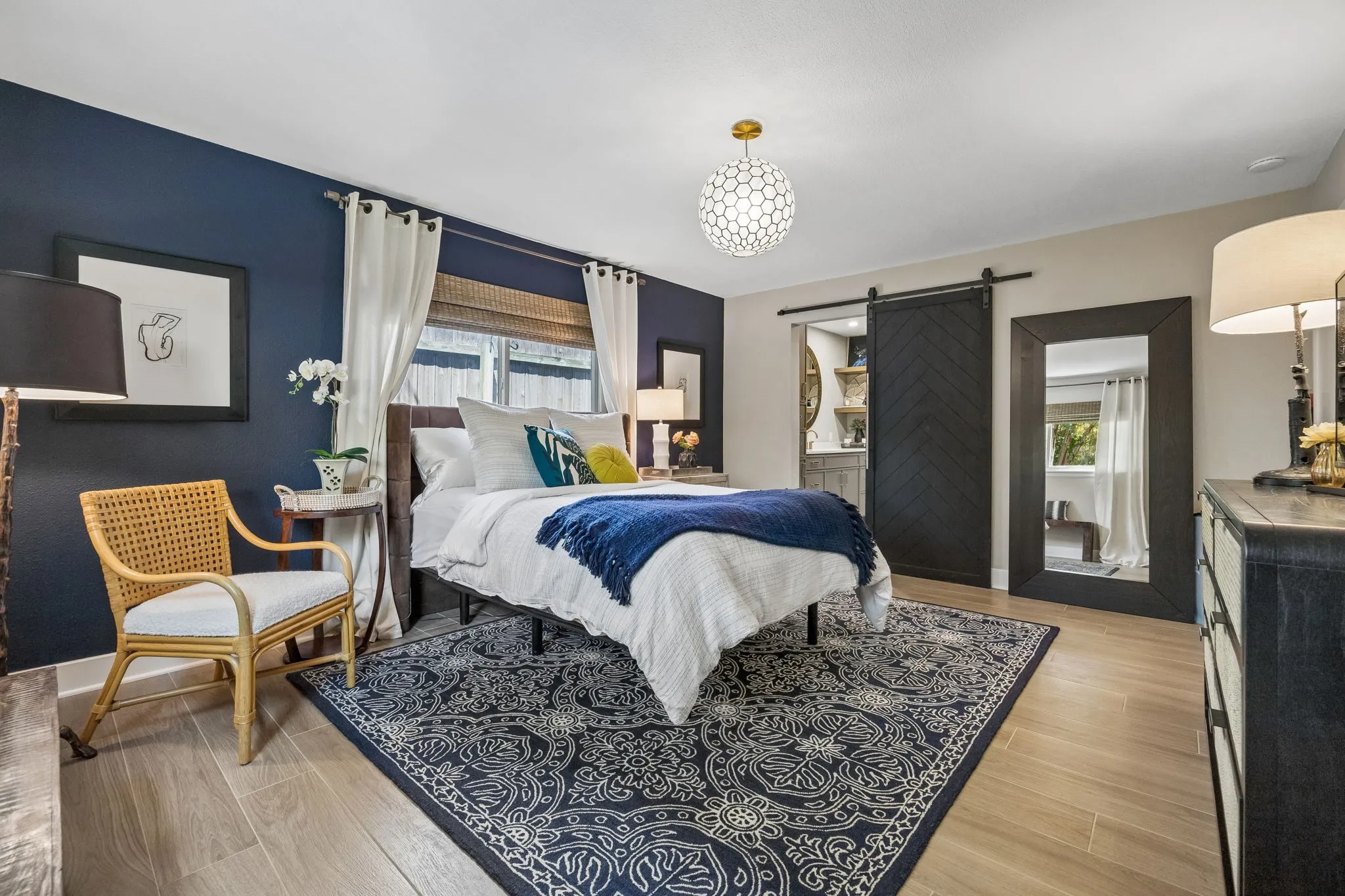 Wood-finish tile flooring with a decorative area rug