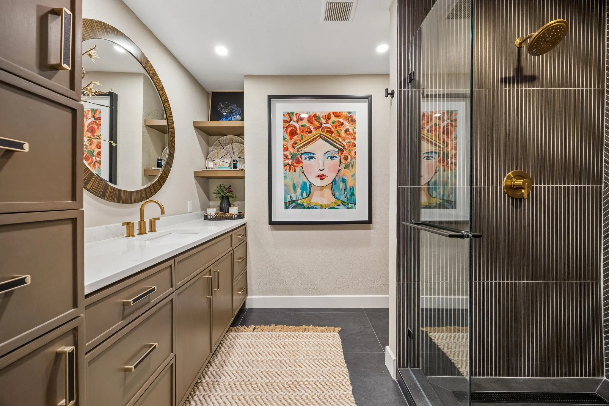 Built-in vanity with a white quartz countertop and gold-finish fixtures