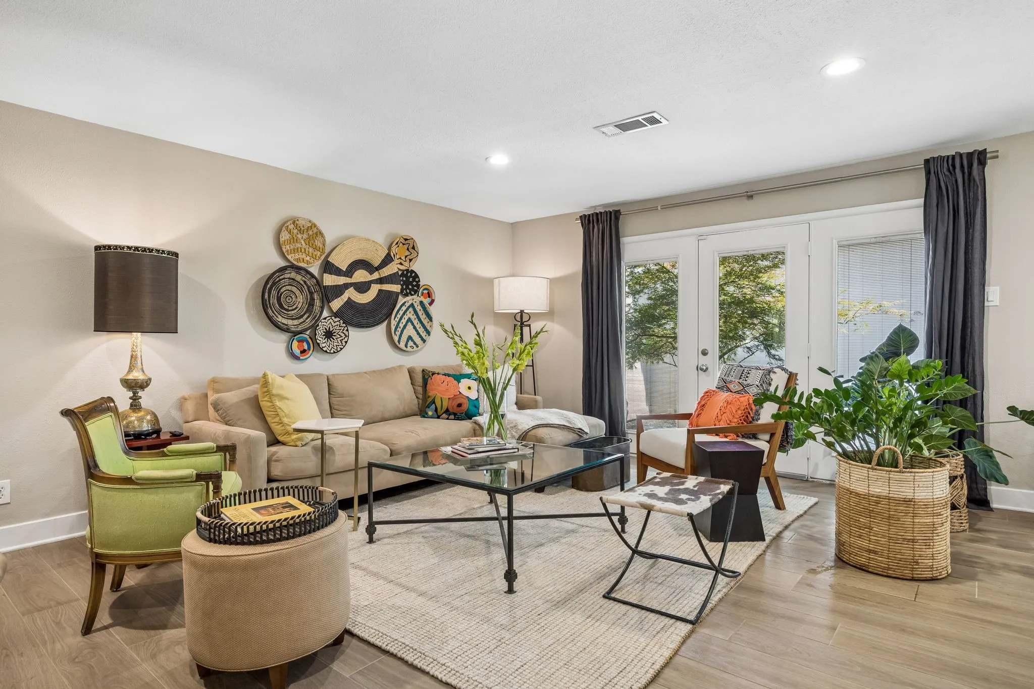 Recessed lighting, wood-finish flooring, light neutral wall tones, and glass-paneled double doors
