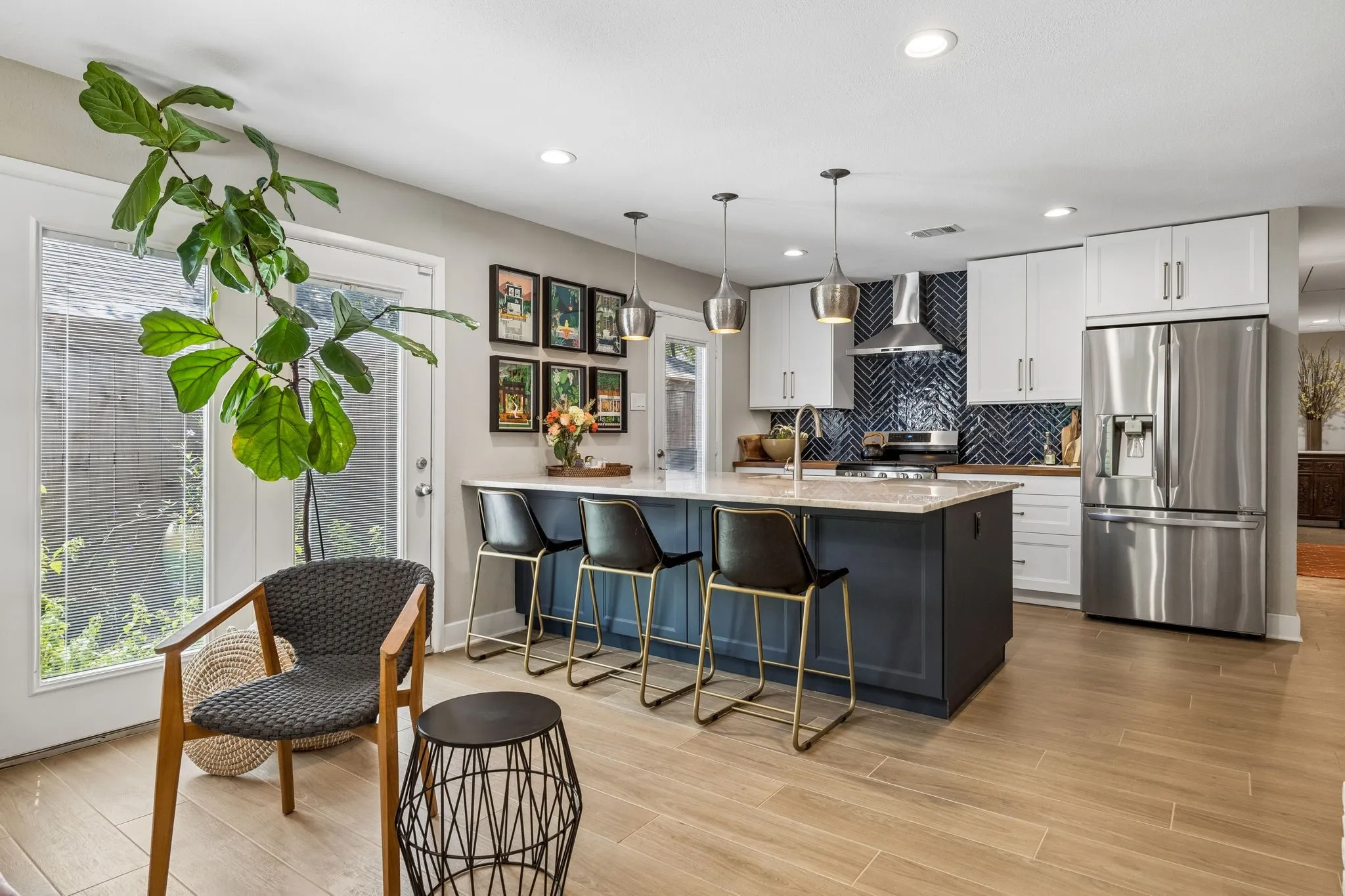 Gourmet kitchen featuring a large island, stainless steel appliances, herringbone tile backsplash, recessed lighting, and tile flooring