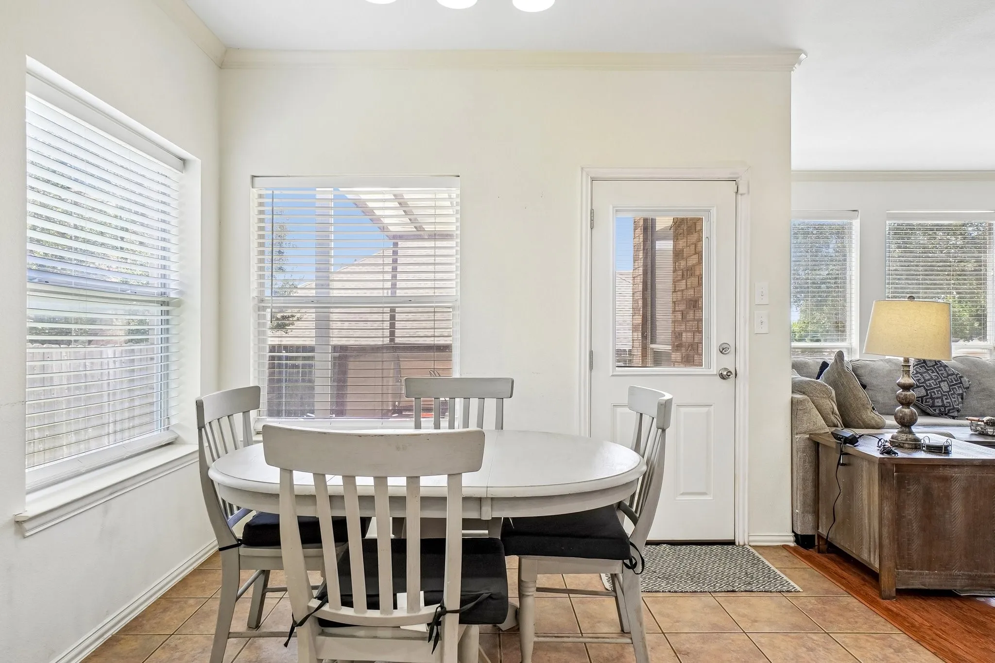 Kitchen dining area with tile flooring and multiple windows