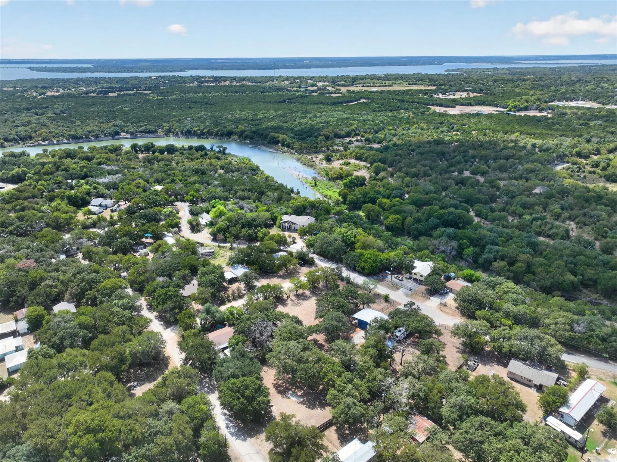 Expansive wooded setting with distant body of water
