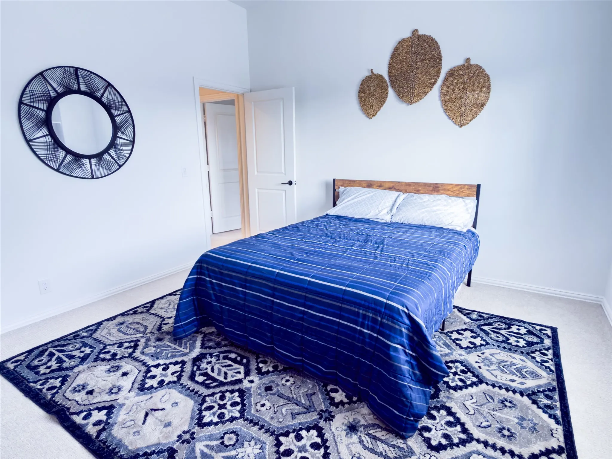 Bedroom featuring light carpet and baseboards