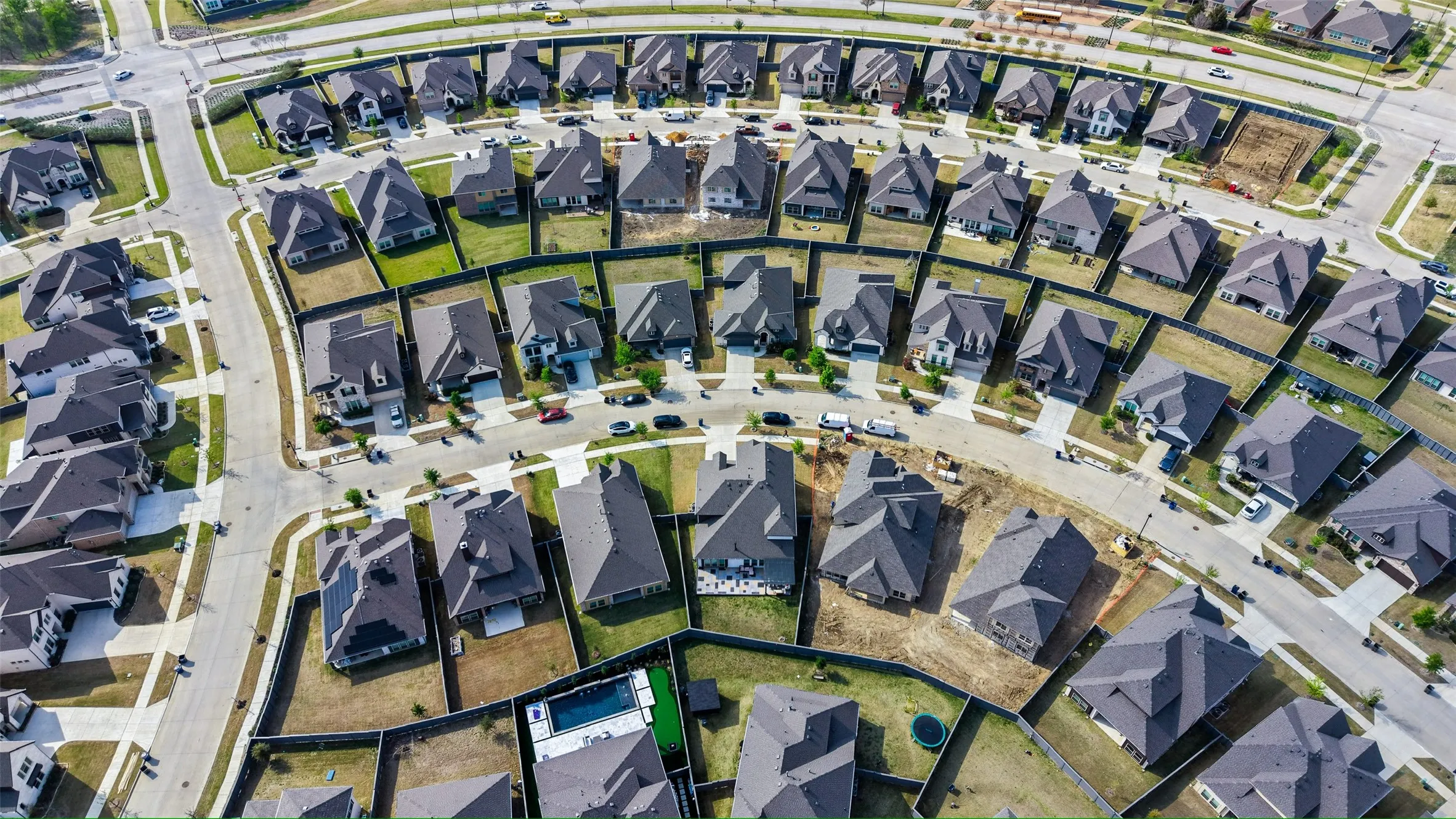 Aerial view of property and surrounding area with nearby suburban area