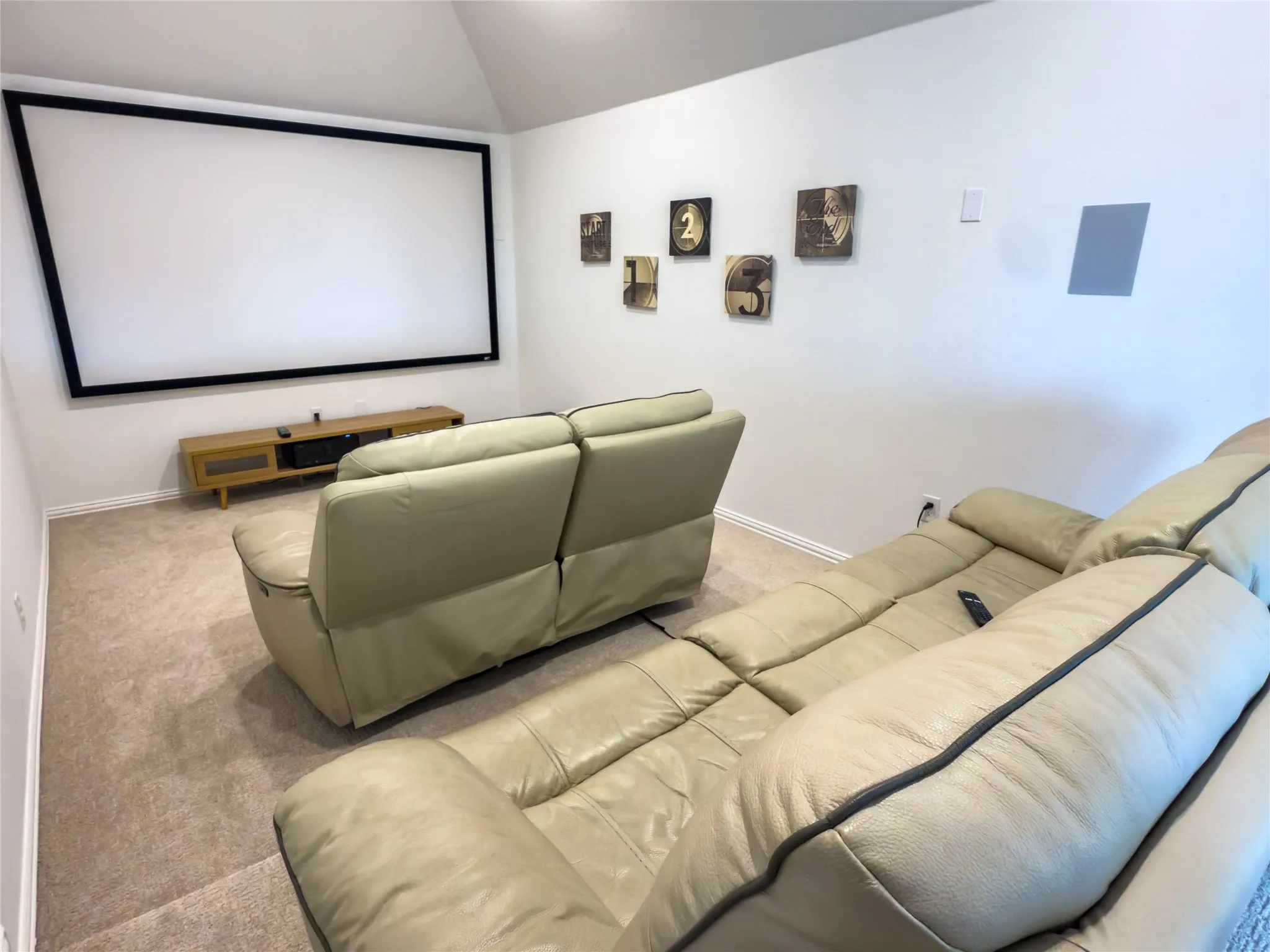 Home theater with carpet flooring and lofted ceiling