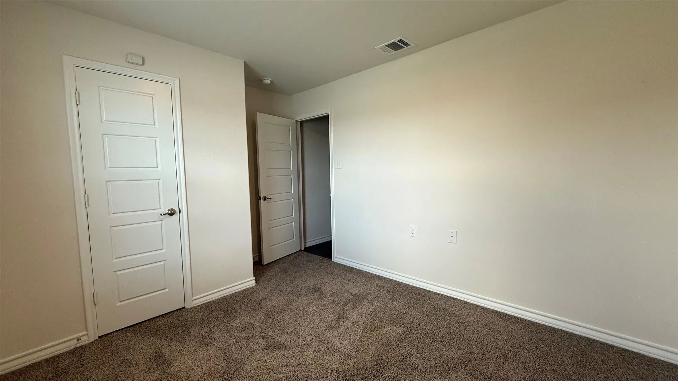Plush carpeting with neutral wall tones and white trim
