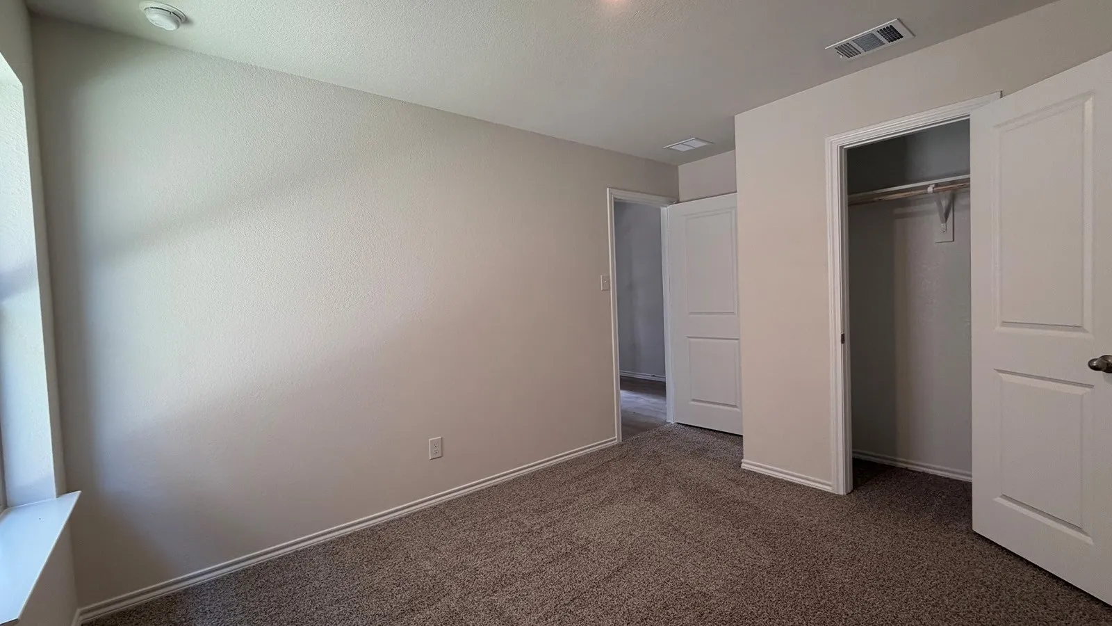 Neutral-toned carpeting paired with light-colored walls