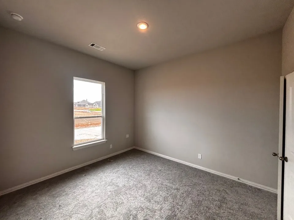 Carpeted flooring, neutral wall tones, recessed ceiling light, and white trim