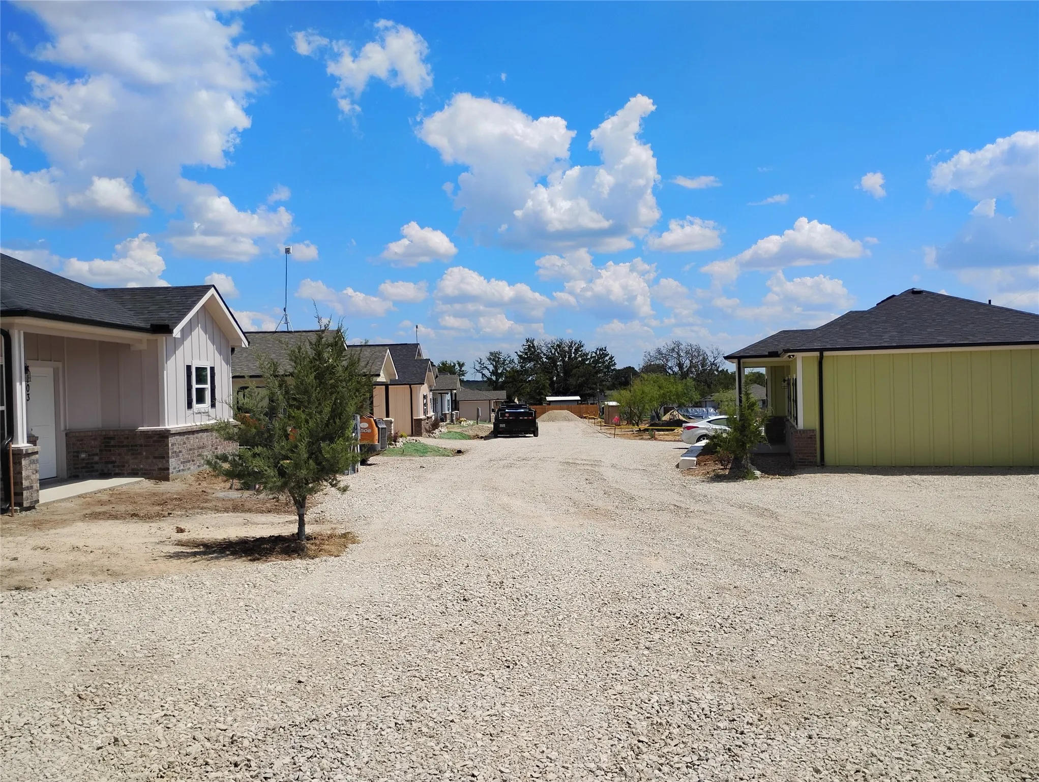 Gravel drive with multiple residential buildings