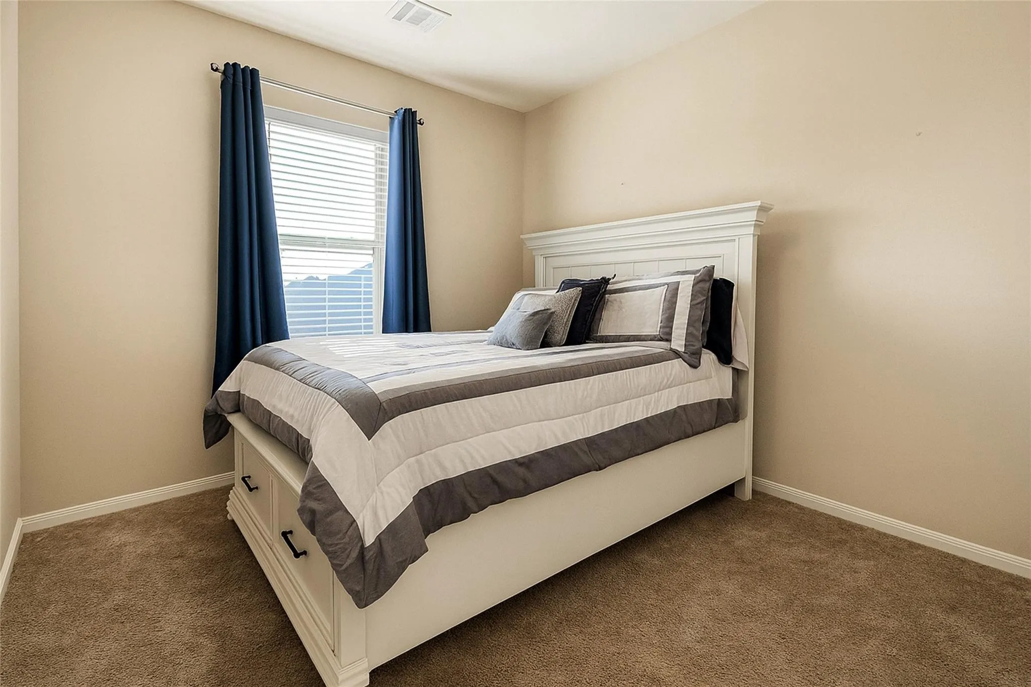 Carpeted flooring, neutral wall tones, and a window with blinds