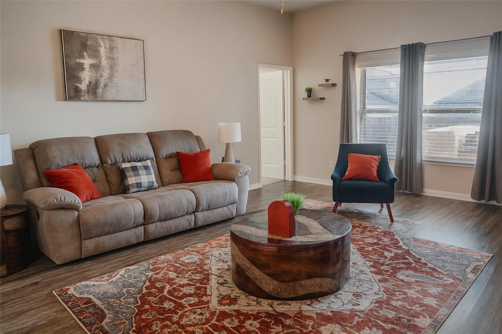 Wood-finish flooring throughout, multiple windows, high ceilings, and light-toned wall finishes