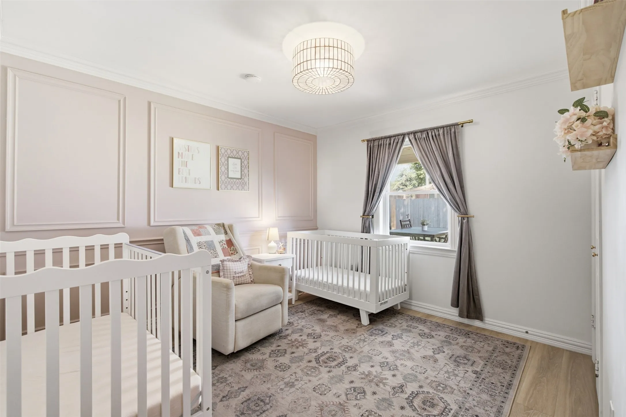 White walls, wood-finish flooring, and a decorative ceiling light fixture