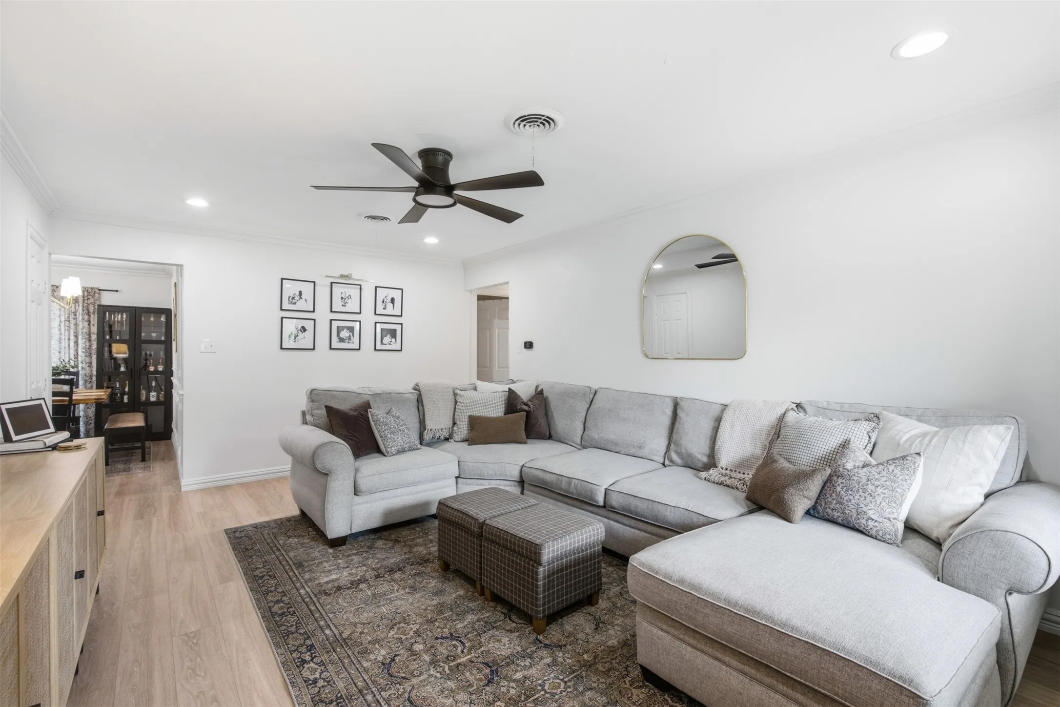 Recessed lighting, wood-finish flooring, ceiling fan, and crown molding