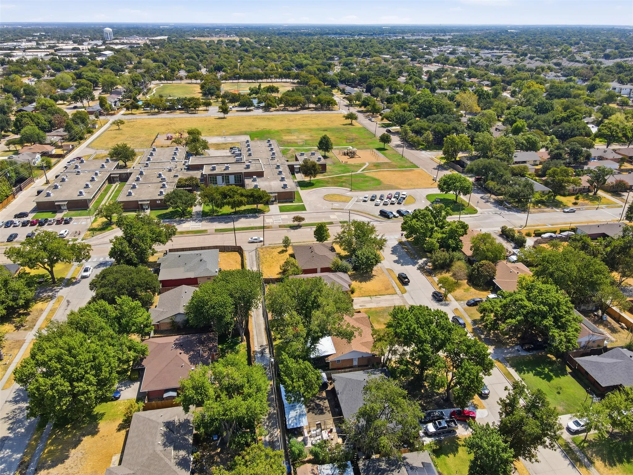Aerial perspective showcasing a residential area with mature trees and established properties