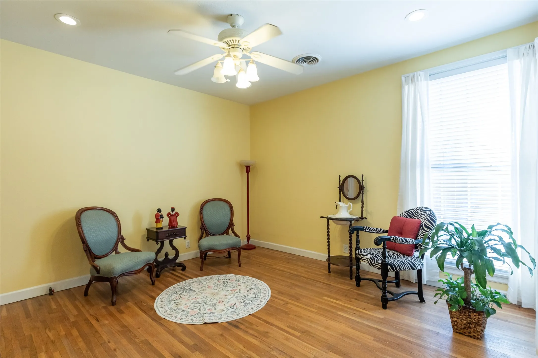 Recessed lighting, wood-finish flooring, ceiling fan, window with blinds, and white trim