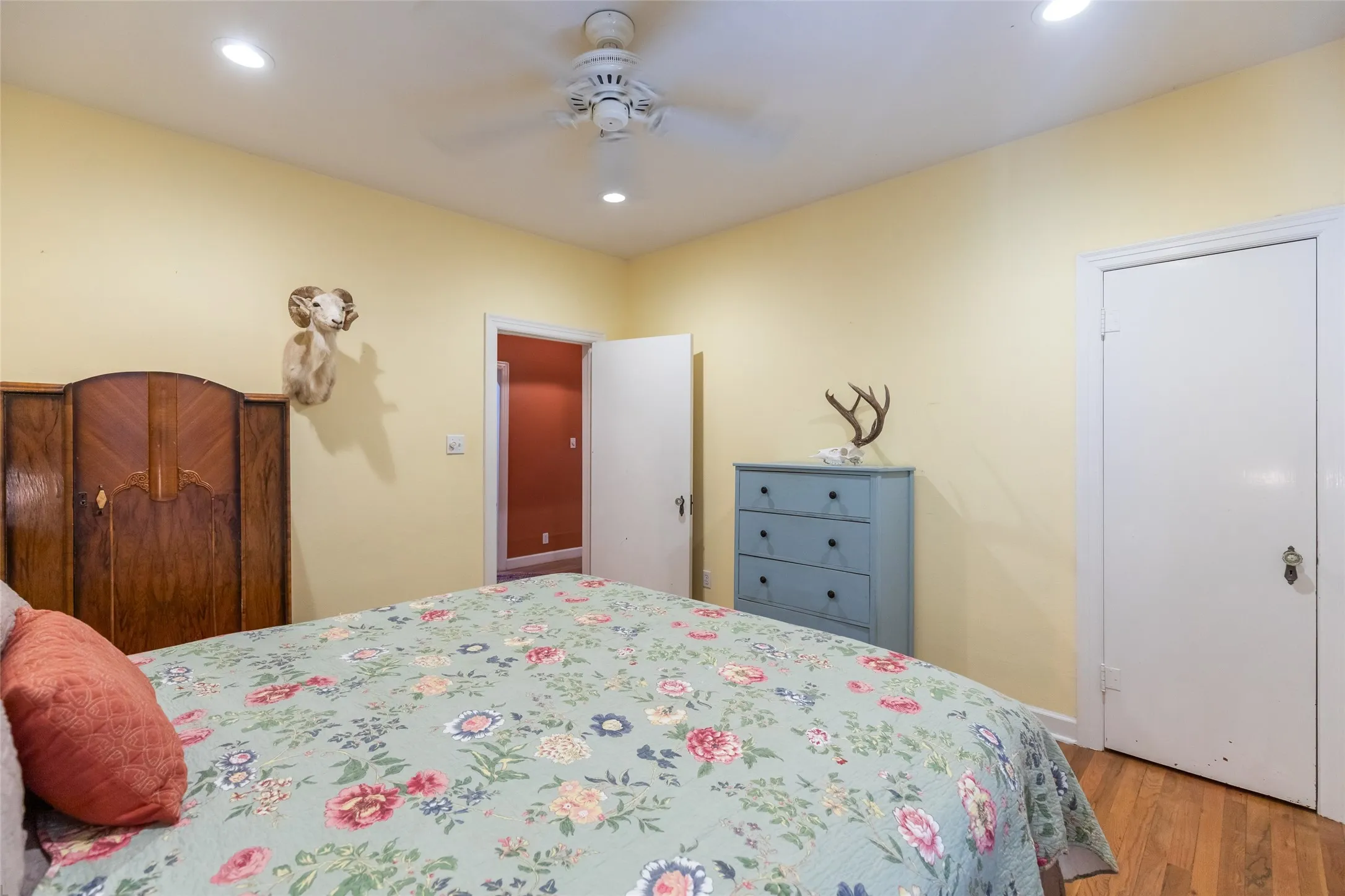 Recessed lighting, wood-finish flooring, and white trim