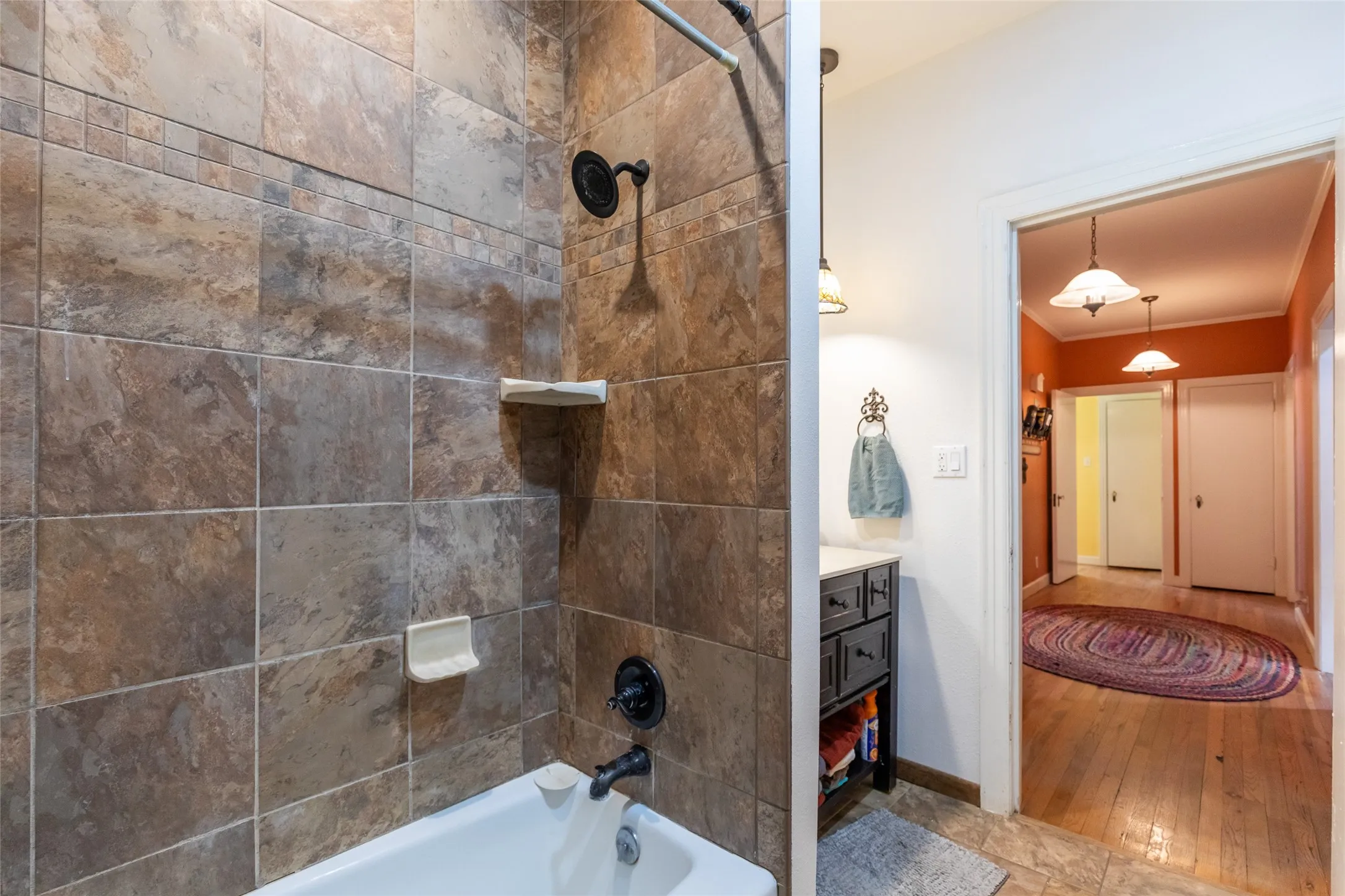 Tub/shower combination with tile surround and dark bronze fixtures