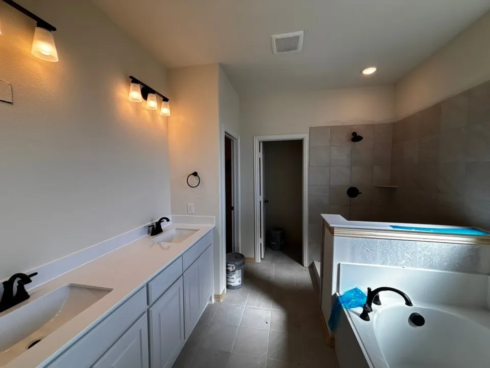 Dual vanity with white countertops, undermount sinks, and matte black fixtures
