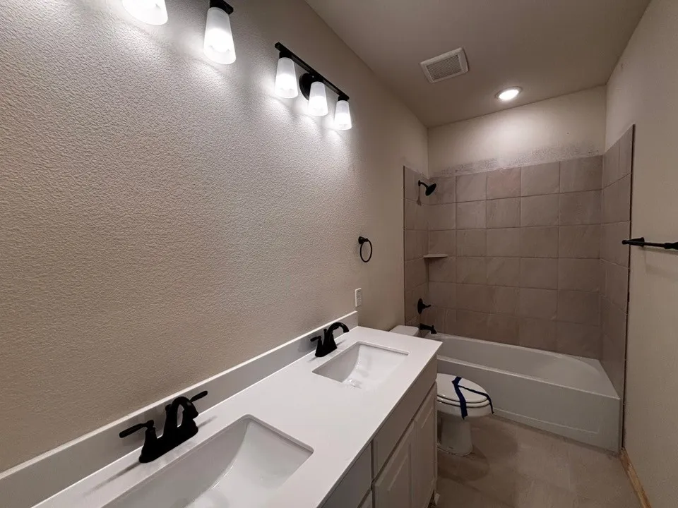 Dual sink vanity with quartz countertop and matte black fixtures