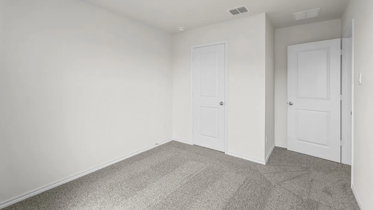 Room featuring light gray wall-to-wall carpeting, white baseboards, and two paneled interior doors