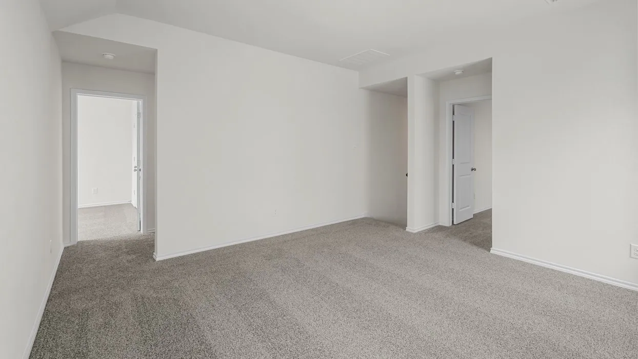 Spacious room featuring neutral carpeting and white wall finishes