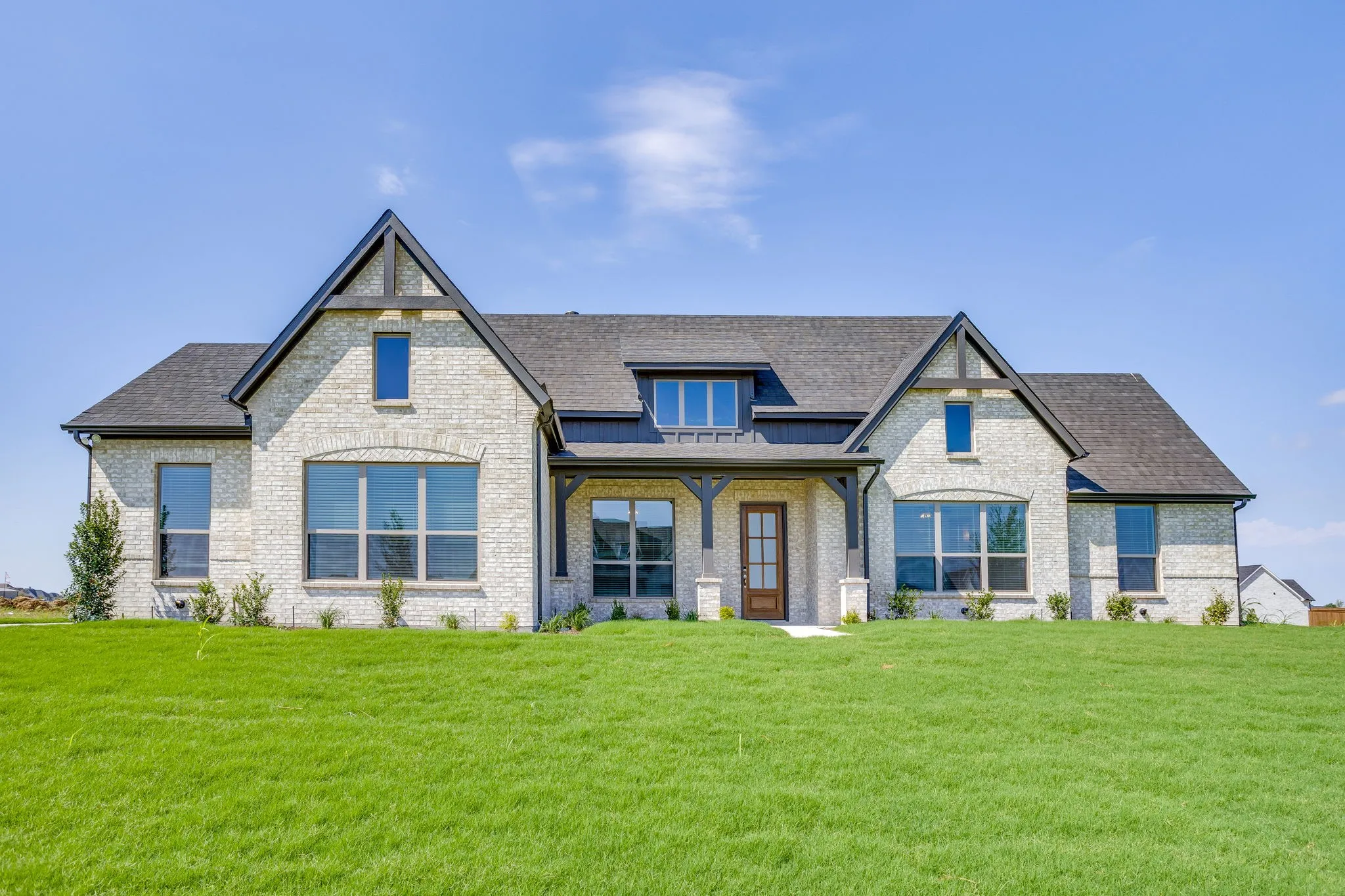 Light-colored brick exterior with dark trim accents
