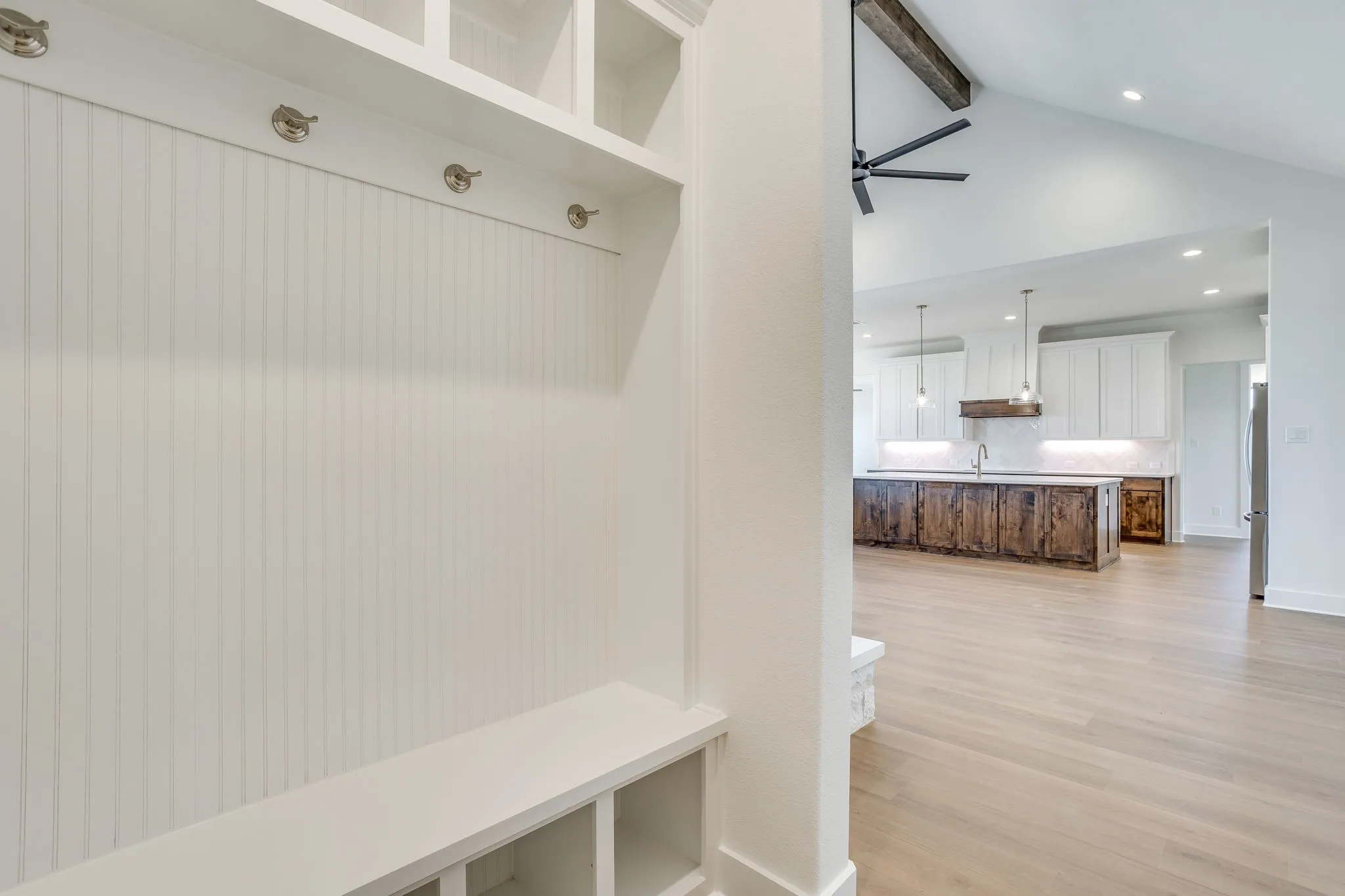 Built-in mudroom bench with coat hooks and overhead cubbies