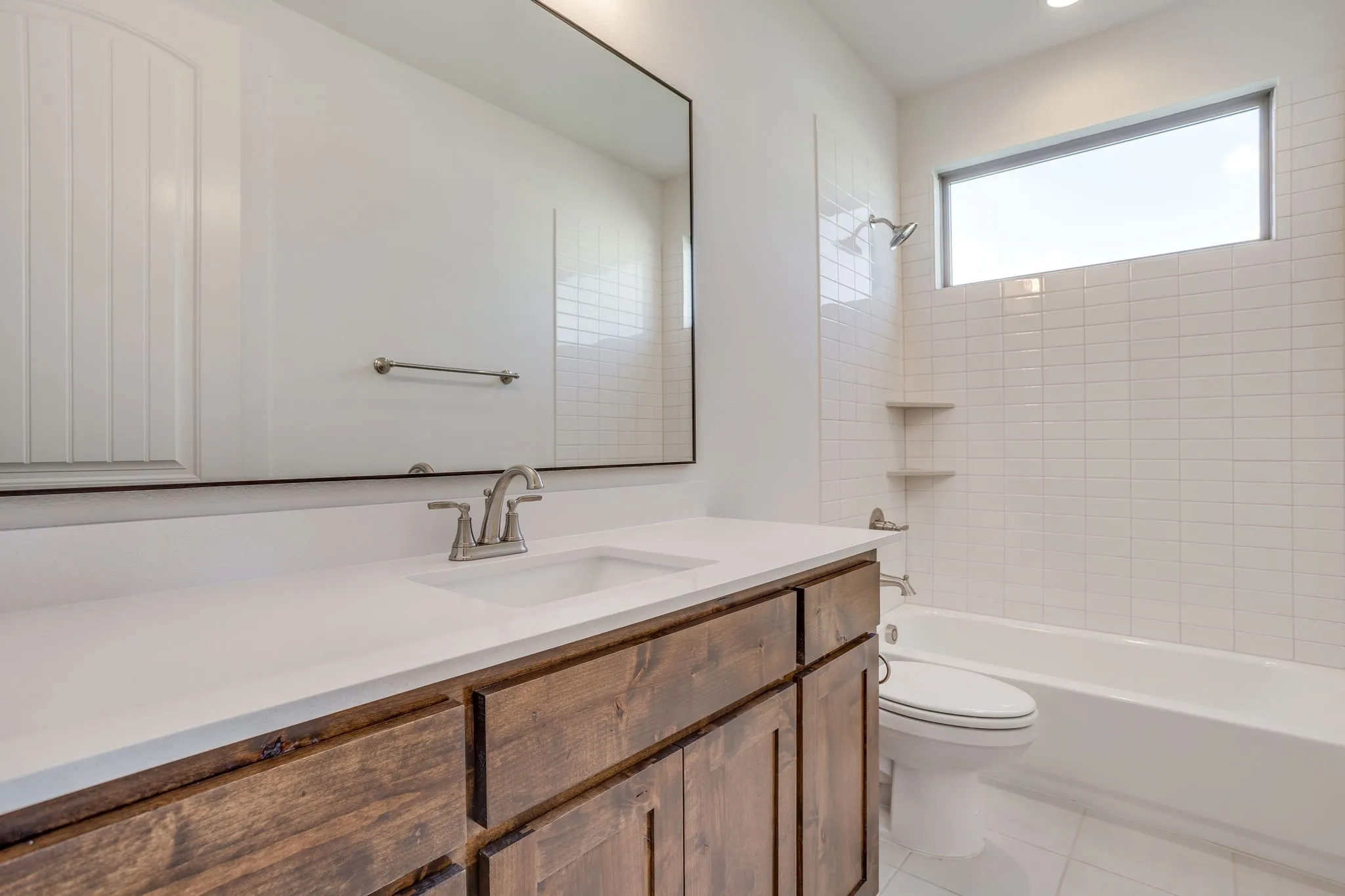 Wood-finish vanity with an integrated rectangular sink and brushed nickel faucet