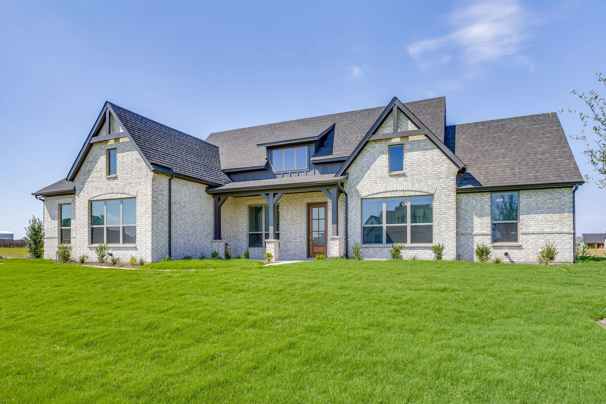 Light-colored brick exterior with dark trim accents