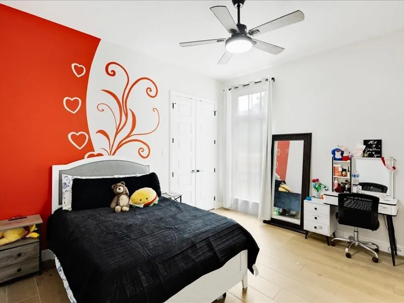 High ceilings complement the wood-finish flooring