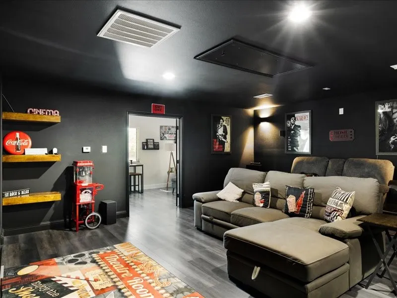 Interior space featuring dark walls, wood-finish flooring, recessed lighting, and wall sconces