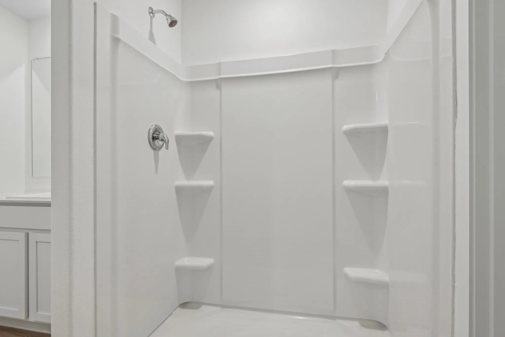 Bathroom featuring vanity and a shower
