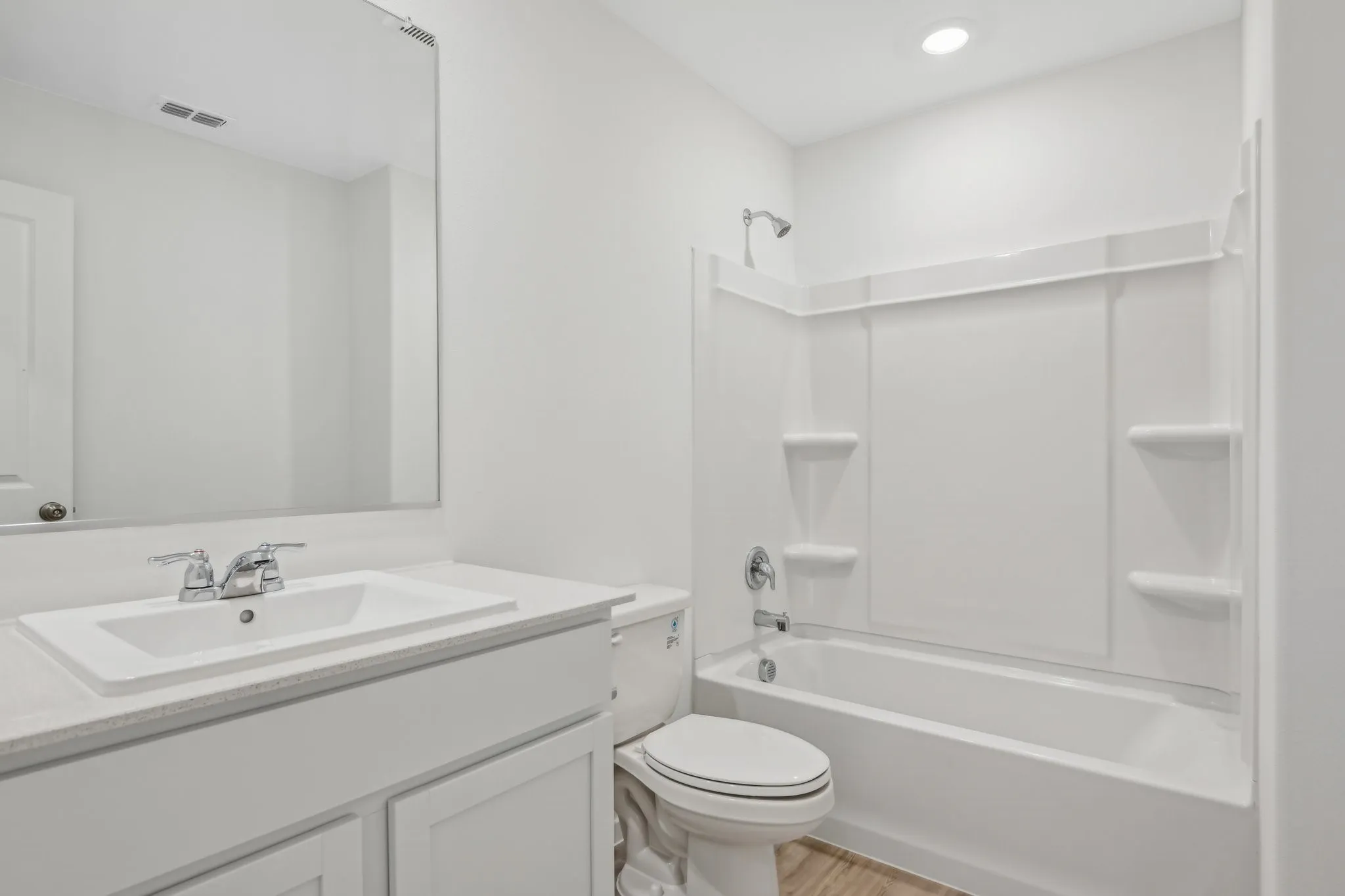 Full bathroom featuring vanity, wood-type flooring, shower / tub combination, and toilet