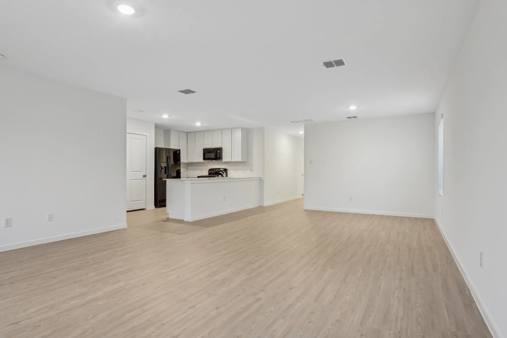 Unfurnished living room featuring light wood-type flooring