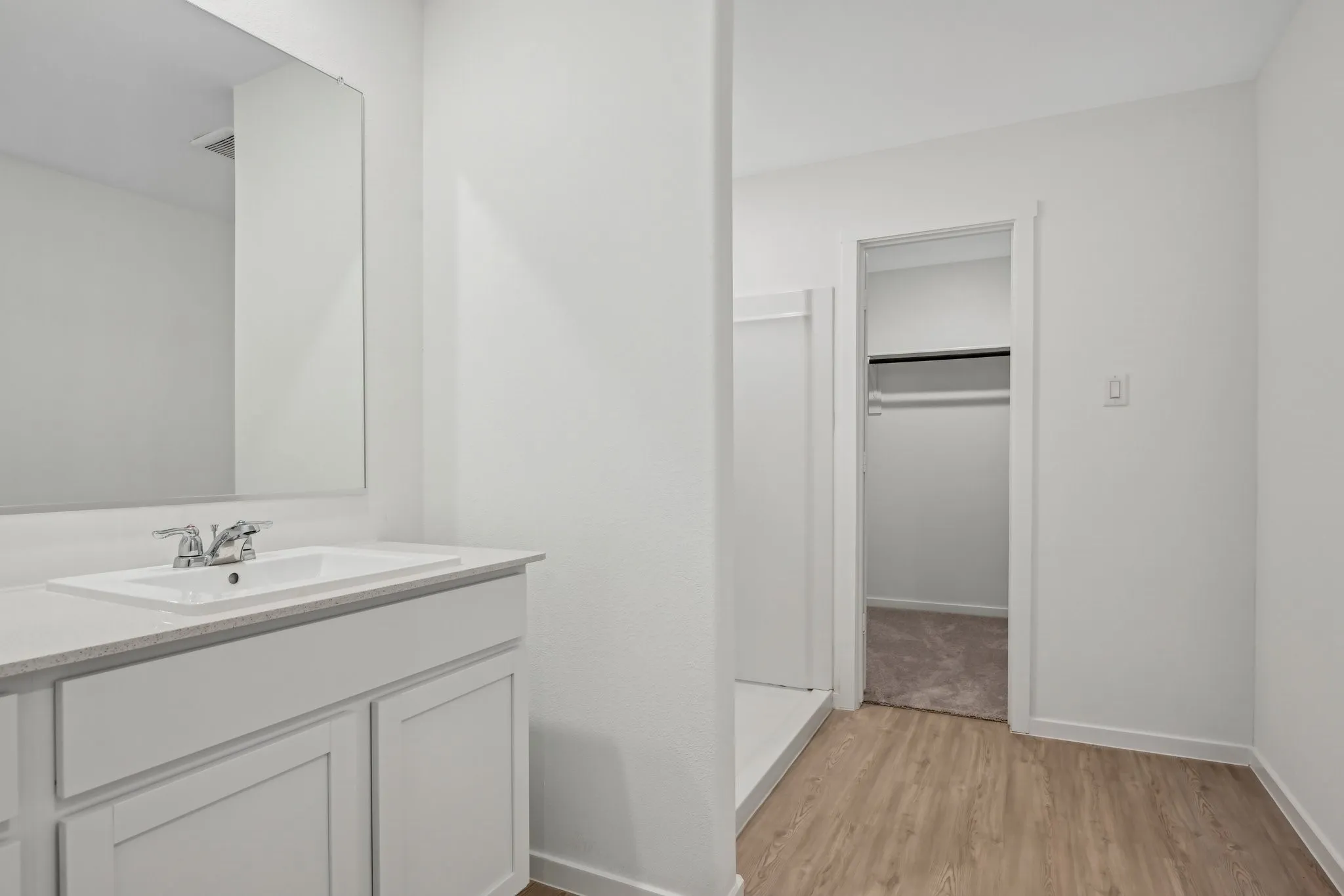 Bathroom featuring vanity, hardwood / wood-style floors, and walk in shower