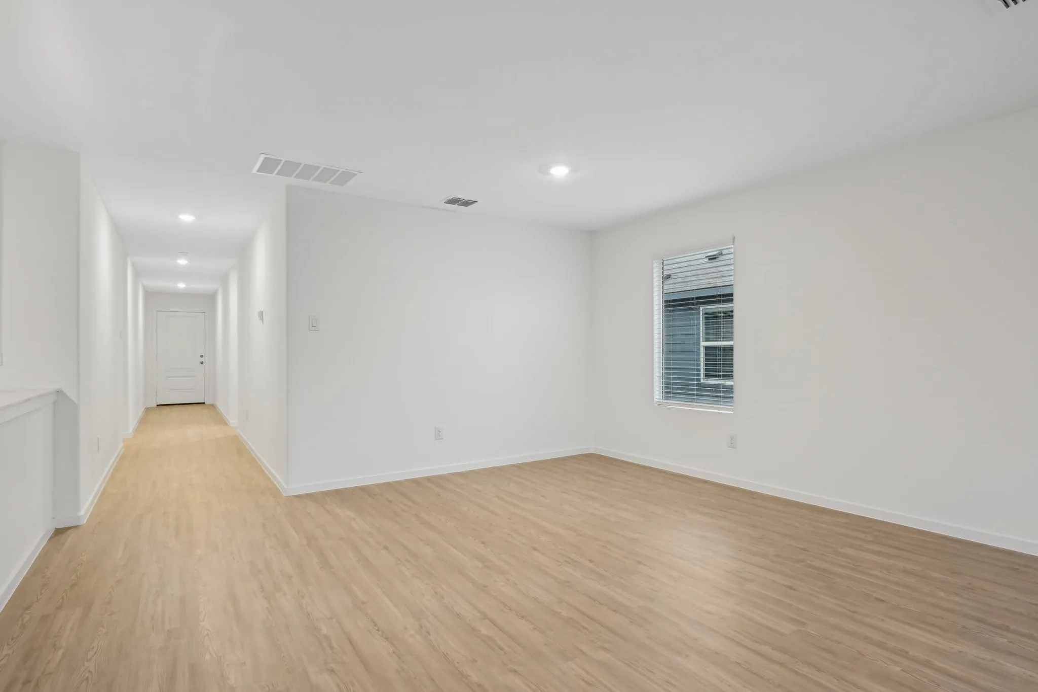 Empty room with light hardwood / wood-style flooring