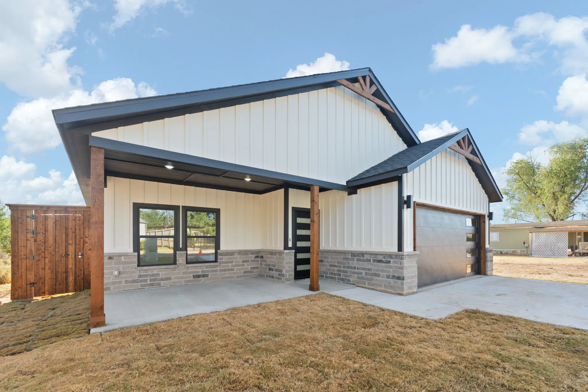 Contemporary exterior with vertical white siding and stone accents