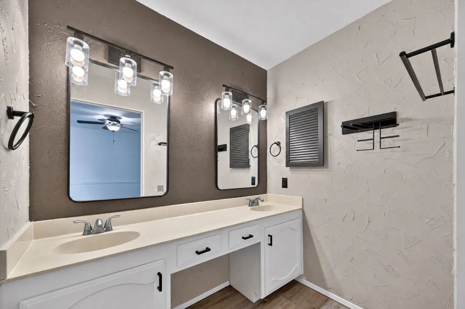 Dual vanity with integrated sinks, white cabinetry, and a light-toned countertop
