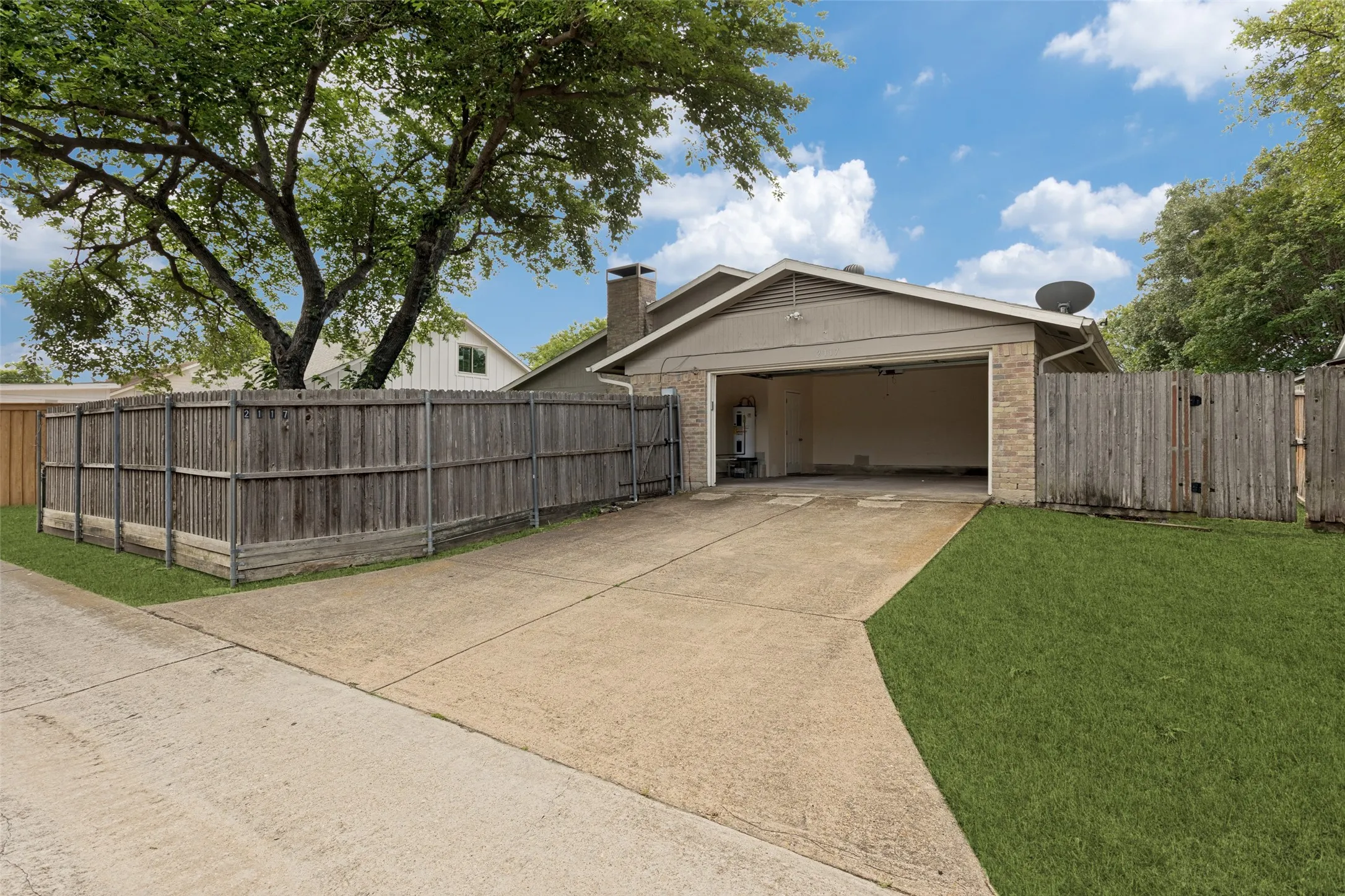 2-car garage with extra storage space, alley access, extra driveway parking.