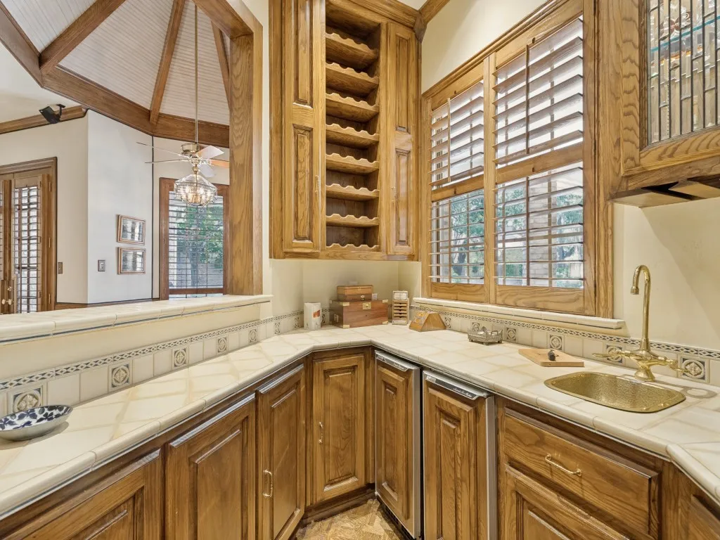 Wet bar featuring built-in fridge and ice machine