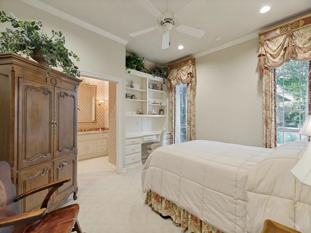 Plush carpet flooring, built-in shelving with desk, recessed lighting, and a ceiling fan