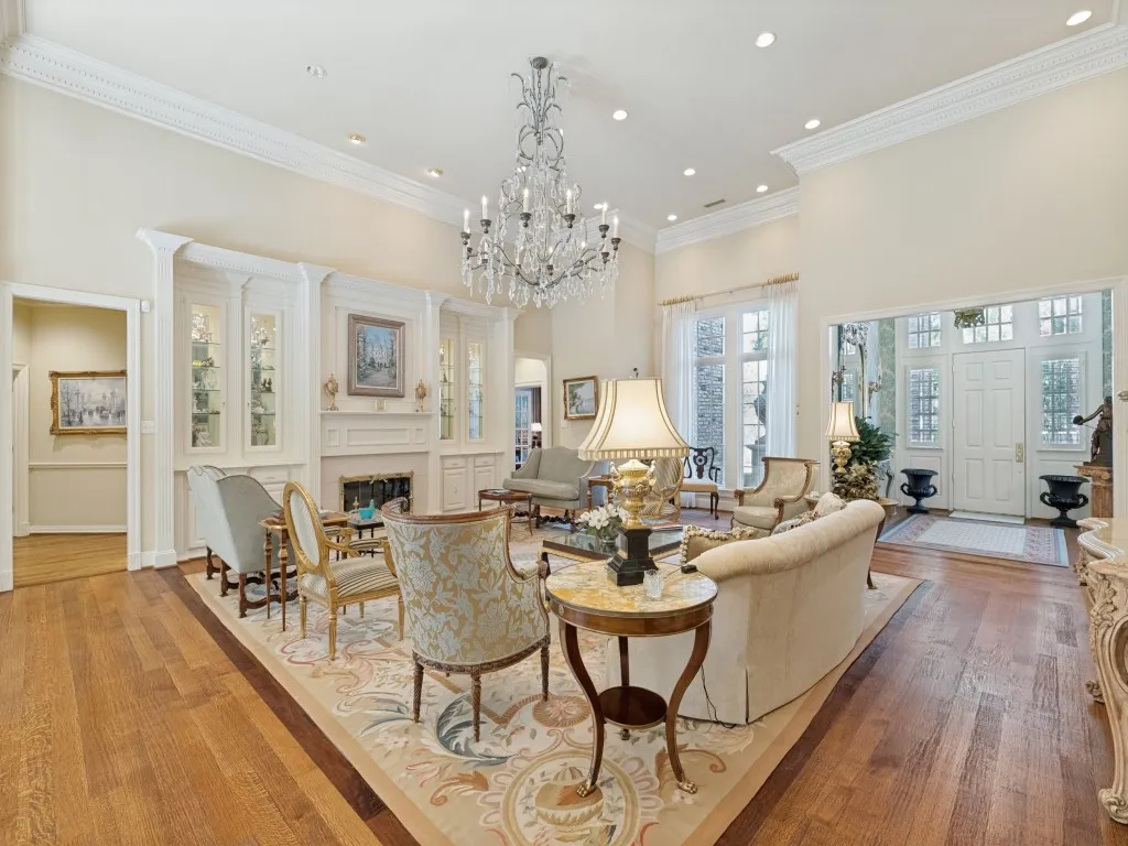 Hardwood flooring, high ceilings with crown molding, recessed lighting, chandelier, built-in cabinetry with fireplace
