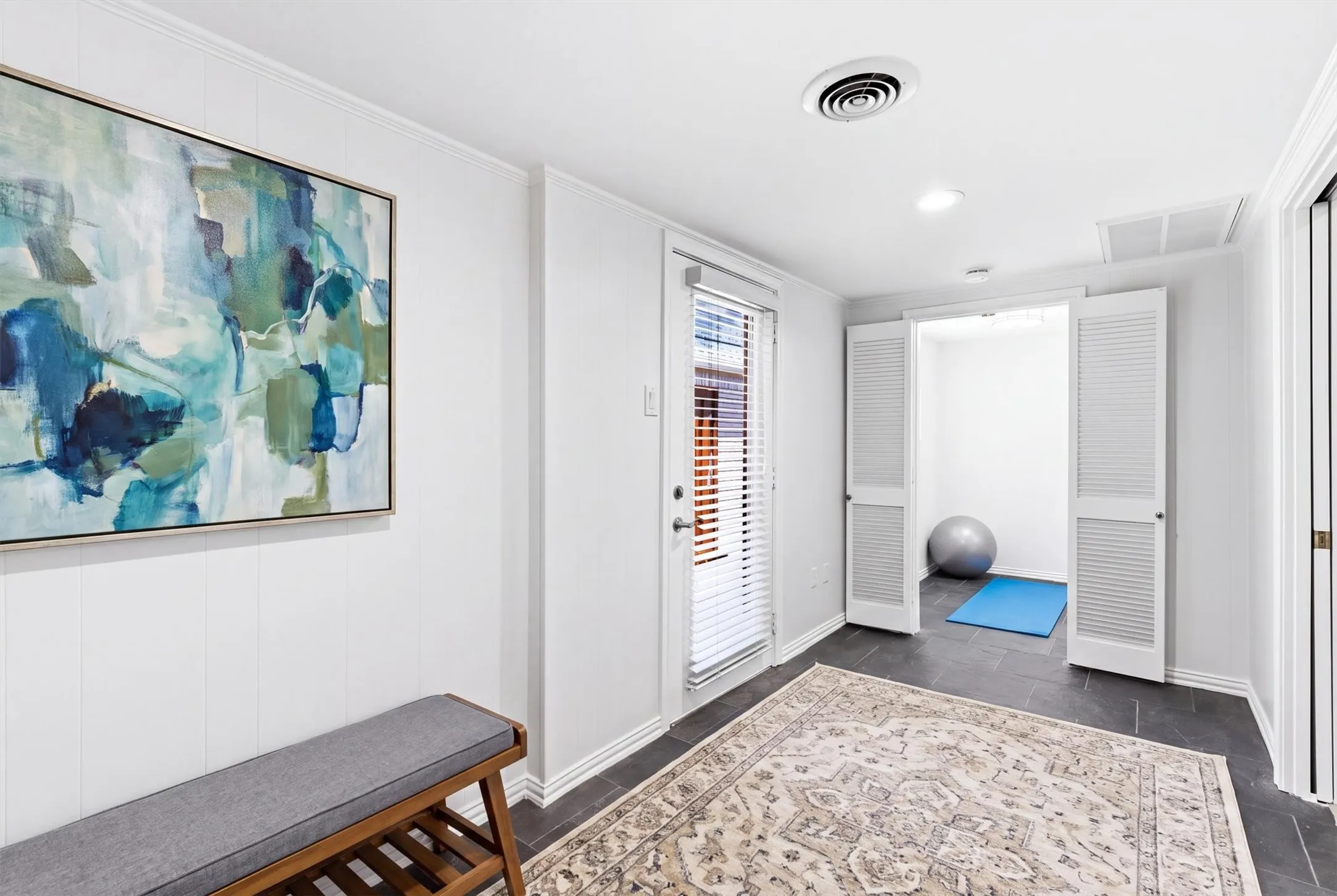 Flex mud room hall corridor with smaller bonus space in the background that would make a good exercise room, hobby room, first floor nursery next to primary or whatever your heart desires....*virtually staged to show potential*