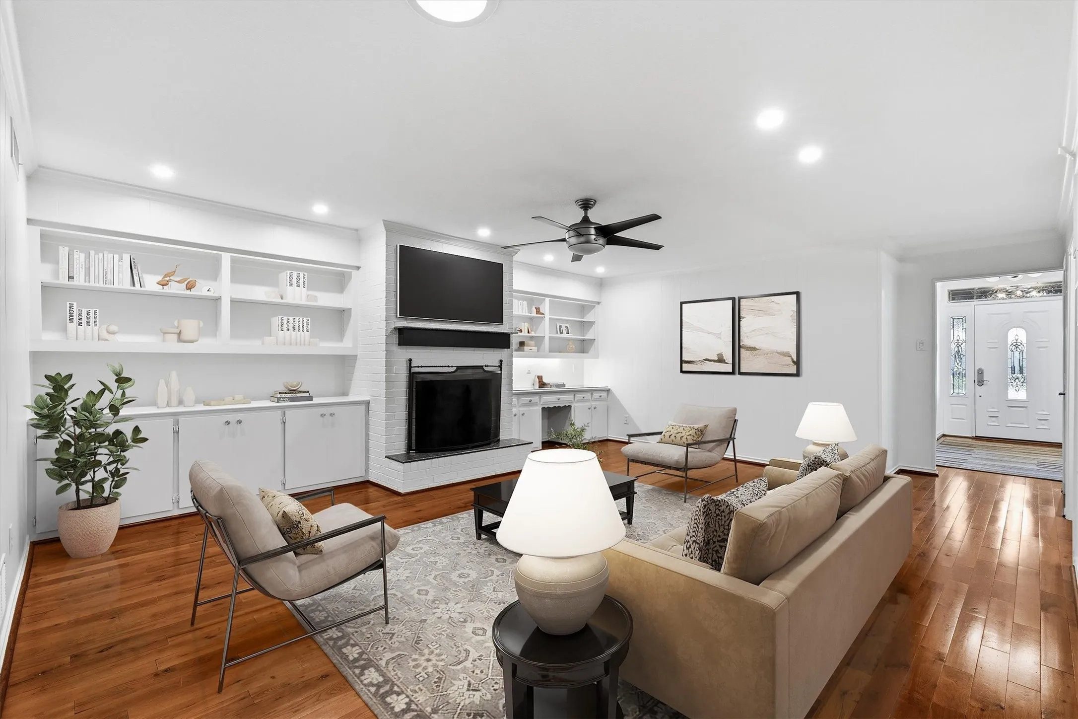 Large family or living room space with hardwood floors, wood burning fireplace, built-ins and wetbar....*virtually staged to show potential*
