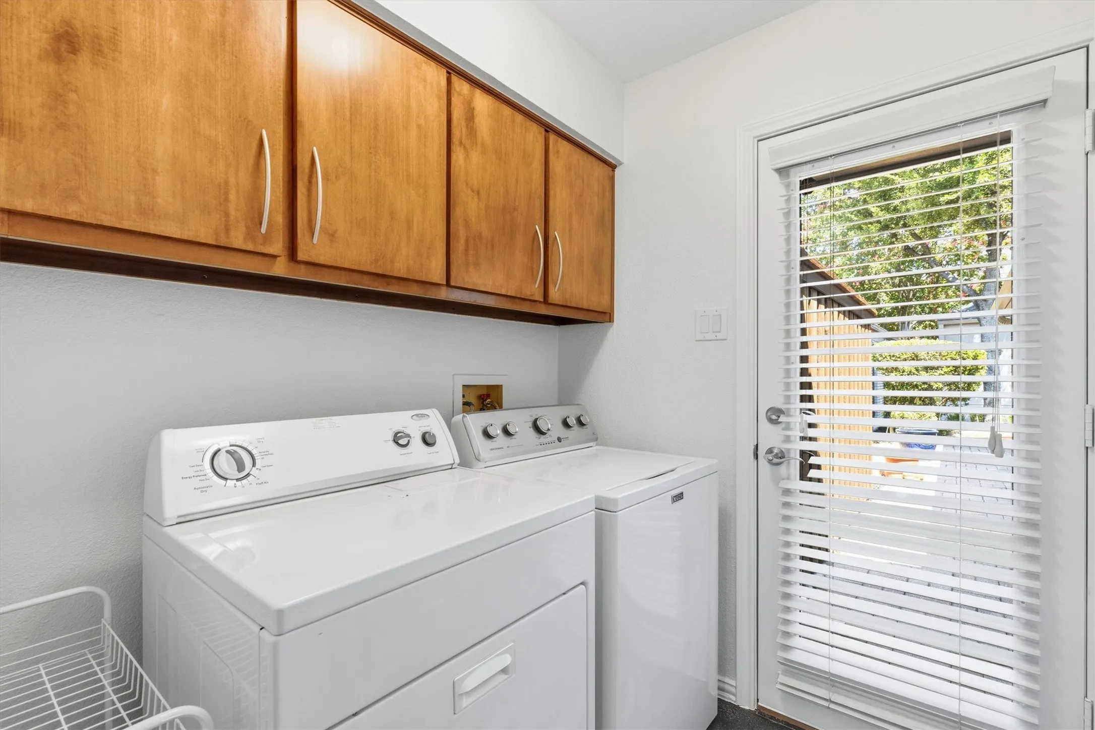 First floor laundry room off kitchen area with custom cabinet storage and an extra closet for additional pantry storage...