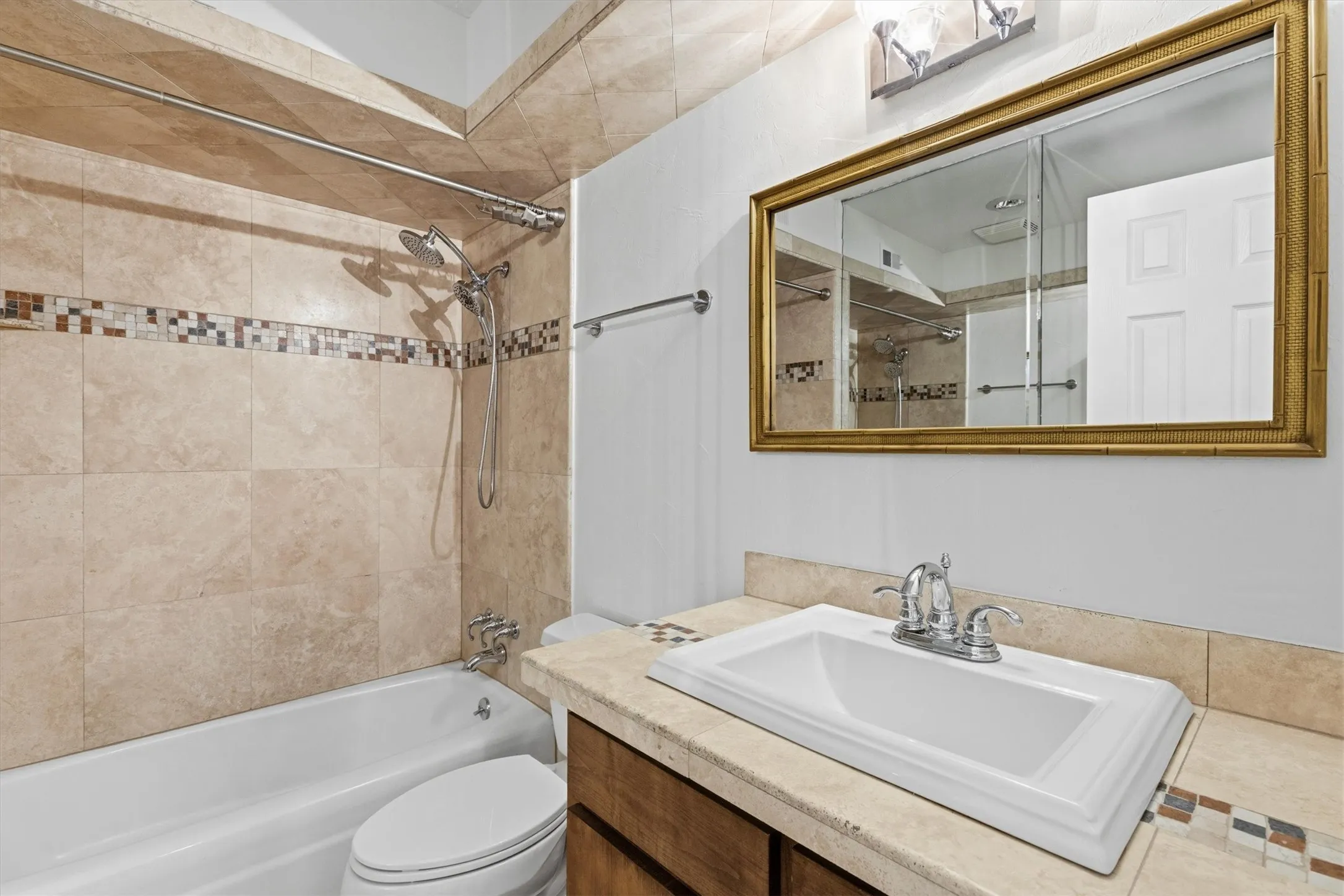 Guest bath upstairs featuring travertine stone...